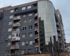 an apartment building with its reflection in the windows at Galina apartment in Ruse