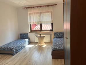 a room with two beds and a window at HOTEL&Restaurant DALLAS in Myślenice