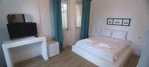 a small bedroom with a bed and a television at Dut Selimiye in Marmaris