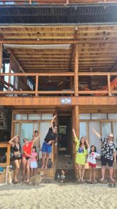 a group of people standing outside of a building at Casa Maya Mendihuaca in Playa Mendiguaca +11 photos