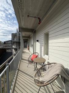 a patio with two chairs and a table on a balcony at Cozy Apartment in Tromsø