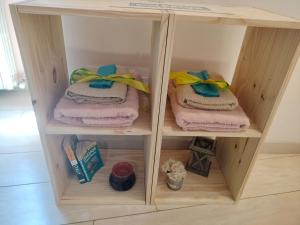 a wooden cabinet with folded towels in it at Apartments Aurora Delle Rose in Assisi +176 photos