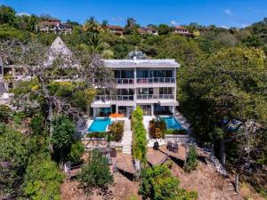 an aerial view of a house with a swimming pool at Casa White#2 Beautiful modern beach house in Sámara
