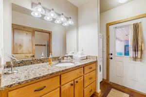 a bathroom with a sink and a large mirror at Deer Trail in McCall +14 photos