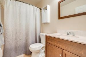 a bathroom with a toilet and a sink and a mirror at Walk to Downtown Prescott with Fenced Yard! in Prescott +16 photos