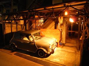 an old car parked in a garage at night at Hostel Oomori Souko in Tokyo