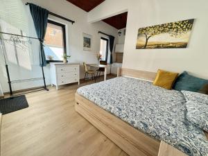 a bedroom with a bed and a desk at Little park house with car charger in Stupava