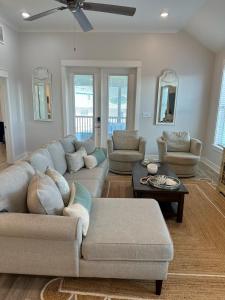 a living room with a couch and a table at Sunset Sanctuary in Dauphin Island +34 photos