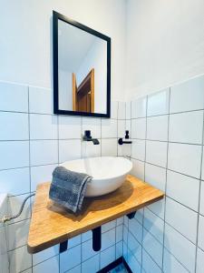 a bathroom with a white sink and a mirror at Landglück in Tettnang +17 photos