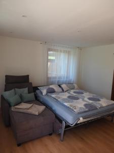 a bed and a couch in a room at Landglück in Tettnang