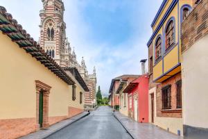 an empty street in a city with a church at Chic 4BR Getaway in Vibrant La Candelaria in Bogotá