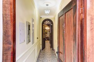 a hallway with a door and a tile floor at Chic 4BR Getaway in Vibrant La Candelaria in Bogotá