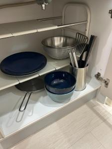 a kitchen shelf with two blue plates and utensils at Yellow Submarine - Vacation STAY 67585v in Naha +11 photos