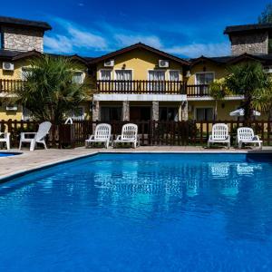 a pool with chairs and a house in the background at Posada Yumei in Villa General Belgrano +20 photos