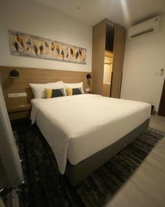 a large white bed in a hotel room at Kashi Gange in Varanasi