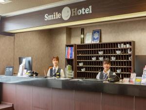two people sitting at a counter in a smile hotel at Smile Hotel Kushiro - Vacation STAY 69842v in Kushiro
