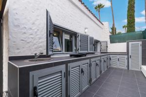 a bathroom with a sink and a building at Dreams Home in Maspalomas