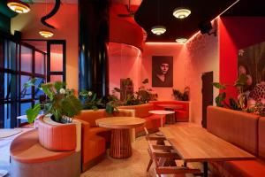 a restaurant with tables and chairs and plants at Calle Flora Hotel by Jalo in Medellín