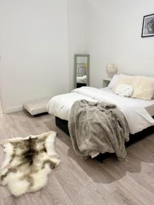 a bedroom with a bed and a rug on the floor at Edgbaston Retreat-Birmingham City Centre-Double Room in a shared two bedroom apartment in Birmingham