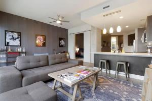 a living room with a couch and a table at The Stevie Ray Vaughan Flat ATX in Austin