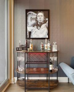 a table with bottles of alcohol on it in a room at The Stevie Ray Vaughan Flat ATX in Austin