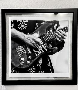 a picture of a person holding a guitar at The Stevie Ray Vaughan Flat ATX in Austin +35 photos