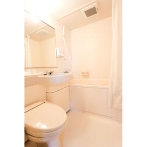 a bathroom with a toilet and a sink and a tub at Smile Hotel Shiogama - Vacation STAY 84726v in Shiogama