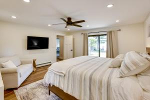 a bedroom with a bed and a ceiling fan at Swim, Fish and Boat House on Stunning Higgins Lake! in Higgins Lake