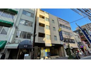 a tall building on a city street with buildings at Smile Hotel Kobe Motomachi - Vacation STAY 85859v in Kobe