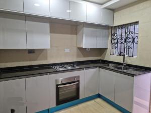 a kitchen with white cabinets and a stove top oven at Exclusive Chalet - 2 Bedroom in Ilerin