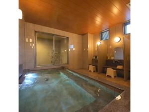 a bathroom with a swimming pool with a sink at Smile Hotel Anan - Vacation STAY 88776v in Anan +7 photos