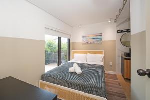 a bedroom with a large bed with a white pillow at Luxury RiverFront By Renzzi in Miami