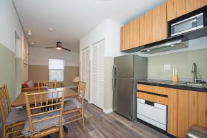 a kitchen and dining room with a stainless steel refrigerator at Luxury RiverFront By Renzzi in Miami +26 photos