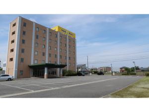 a building with a parking lot in front of it at Smile Hotel Shizuoka Yoshida Inter - Vacation STAY 90908v 