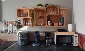 a kitchen counter with a microwave on a counter top at La Péra in Putanges +18 photos