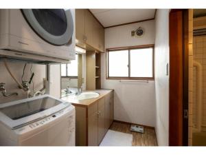 a small kitchen with a washing machine and a sink at live takayama - Vacation STAY 19761 in Takayama +14 photos