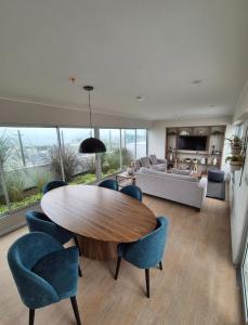 リマにあるHermoso apartamentoのリビングルーム(木製テーブル、青い椅子付)