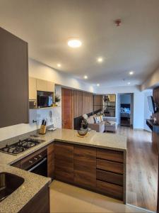 リマにあるHermoso apartamentoのコンロとリビングルームのある広いキッチン