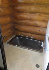 a metal sink in a room with a wooden wall at Noboribetsu City Log House - Vacation STAY 19798 in Noboribetsu