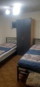 a room with two beds and a cabinet in it at Shamb guest house in Darbas
