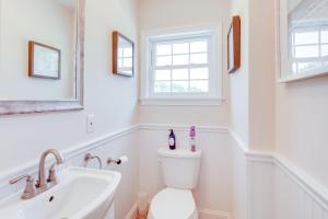 a white bathroom with a toilet and a sink at Walk to Pawcatuck River Family-Friendly Home! in Pawcatuck +28 photos