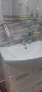 a bathroom sink with a lot of items on it at Shamb guest house in Darbas