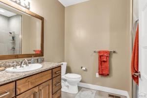 a bathroom with a sink and a toilet and a mirror at Townhome Modern in Pueblo +2 photos