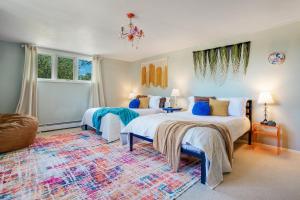 a bedroom with two beds and a rug at Mid-Century Escape 7 BR Sleeps 22 Hot Tub & Games in Westminster