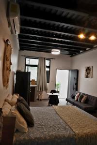 a bedroom with a bed and a living room at Estación 1501 in Juticalpa