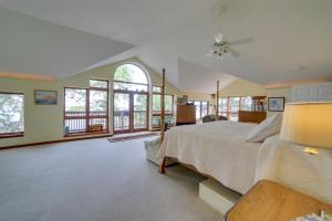 a large bedroom with a large bed and windows at Lakefront Lookout! Private Sand Beach on Superior in Marquette +32 photos