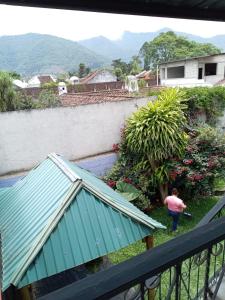 a person walking in the yard of a house at Posada Colonial El Buen Pastor in Antigua Guatemala