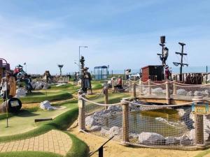 a park with a playground with people playing in it at CT12 The Beach Hut in Rhyl