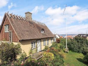an old house with a slate roof on a yard at 4 star holiday home in Humlebæk in Humlebæk