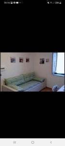 a bed in a bedroom with pictures on the wall at B&B Il Tiglio in Lapio +1 photo